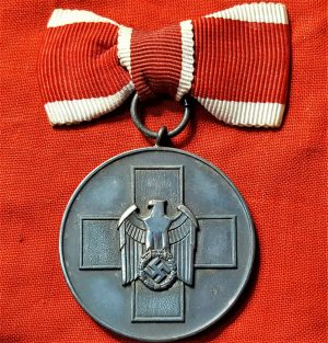 WW2 GERMAN RED CROSS SOCIAL WELFARE MEDAL WITH FEMALE TIED BOW RIBBON